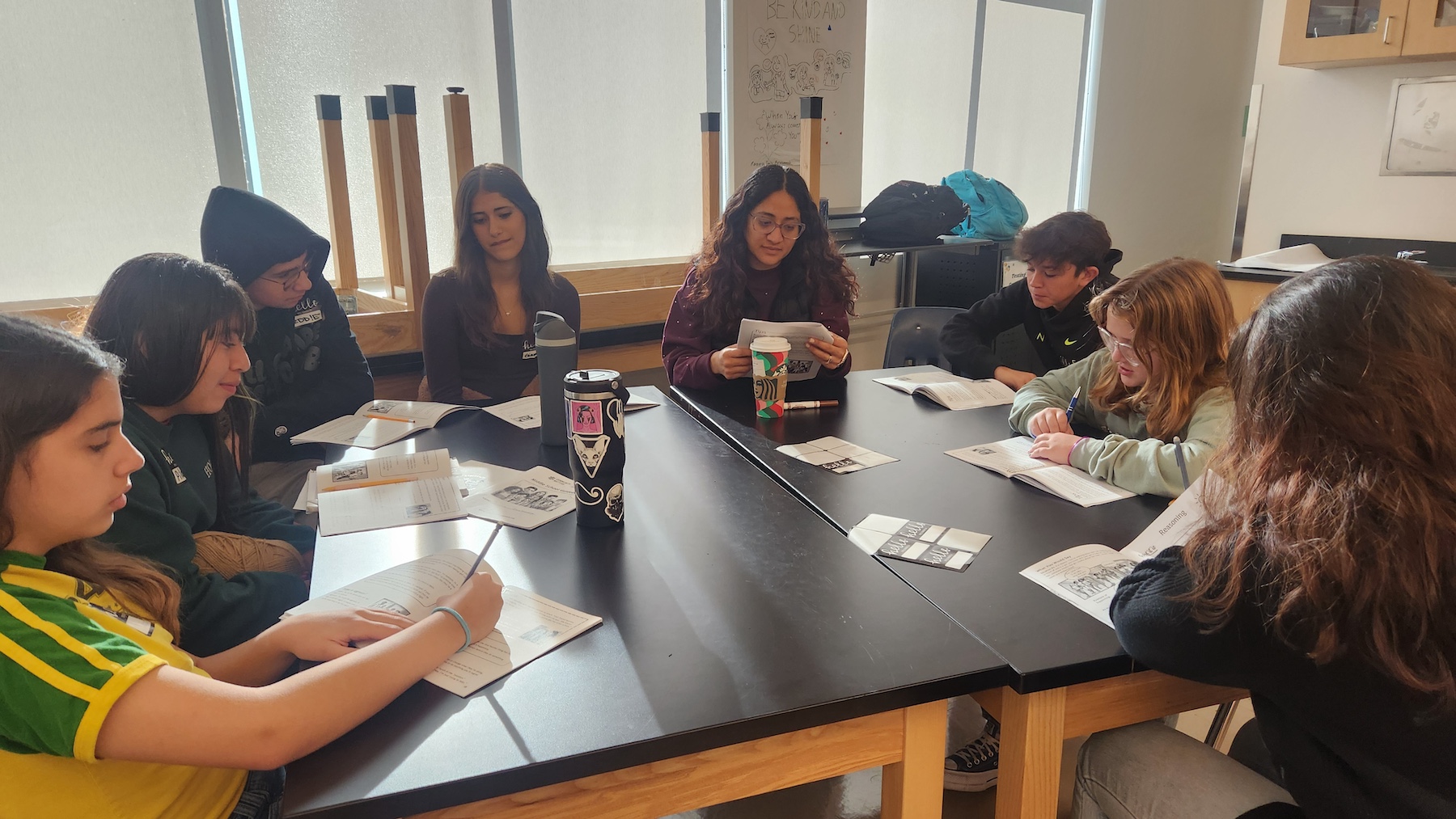 Students in a group talking to each other.